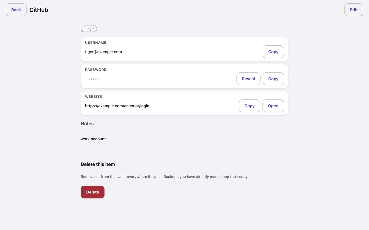 A login item on the desktop: username, concealed password with Copy and Reveal, and a website field with an Open button.
