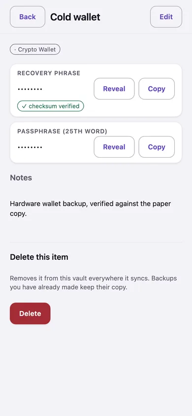 A crypto wallet item on a phone: the recovery phrase concealed, marked checksum verified, with Reveal and Copy buttons.